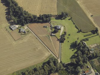 Oblique aerial view centred on the country house and walled garden, taken from the W.