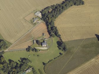 Oblique aerial view centred on the country house and walled garden, taken from the SSW.