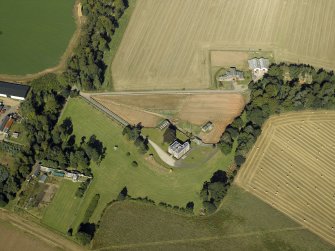 Oblique aerial view centred on the country house and walled garden, taken from the SE.