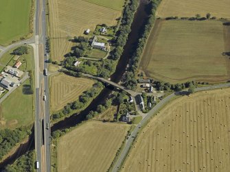 Oblique aerial view centred on the road bridges and tollhouse, taken from the SW.