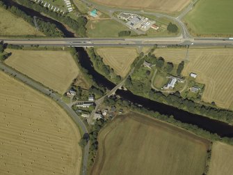 Oblique aerial view centred on the road bridges and tollhouse, taken from the SE.