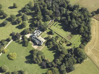 Oblique aerial view centred on the country house and gardens taken from the W.