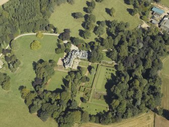Oblique aerial view centred on the country house and gardens taken from the SW.