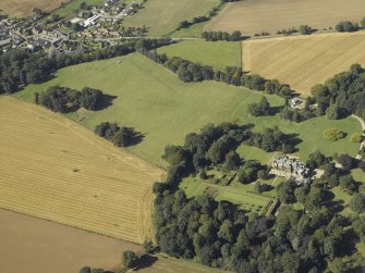 General oblique aerial view centred on the country house and gardens with the cottage adjacent, taken from the ESE.