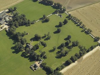 Oblique aerial view centred on the tower-house, dovecot, gardens and stable block, taken from the W.