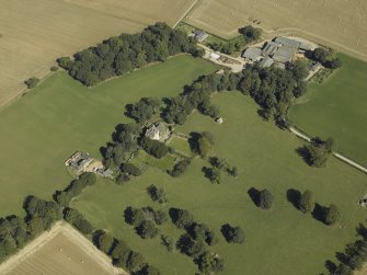 Oblique aerial view centred on the tower-house, dovecot, gardens and stable block, taken from the SW.