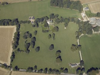 Oblique aerial view centred on the tower-house, dovecot, gardens and stable block, taken from the SSE.