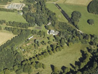 Oblique aerial view centred on the country house and park, taken from the SW.