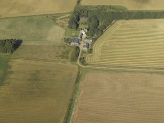 Oblique aerial view centred on the farmhouse, farmsteading and tower-house, taken from the SE.