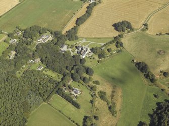 General oblique aerial view centred on the country house, dovecot, summerhouse, gate-lodge and walled garden, taken from the SW.