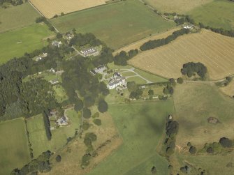 General oblique aerial view centred on the country house, dovecot, summerhouse, gate-lodge and walled garden, taken from the SSE.