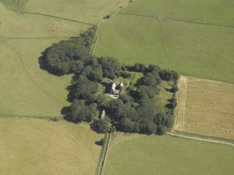 Oblique aerial view centred on the tower-house, stable, dovecot, cottage and walled garden, taken from the WSW.