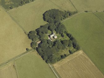 Oblique aerial view centred on the tower-house, stable, dovecot, cottage and walled garden, taken from the SW.