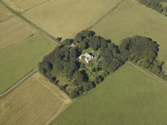 Oblique aerial view centred on the tower-house, stable, dovecot, cottage and walled garden, taken from the ESE.