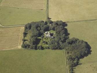 Oblique aerial view centred on the tower-house, stable, dovecot, cottage and walled garden, taken from the ESE.