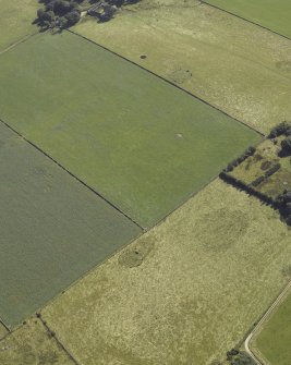 Oblique aerial view centred on the remains of the cairn and stone circle with the remains of the recumbent stone circle adjacent, taken from the NW.