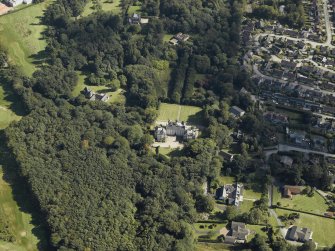 Oblique aerial view centred on the country house, gardens and dovecot with the cottages adjacent, taken from the NW.