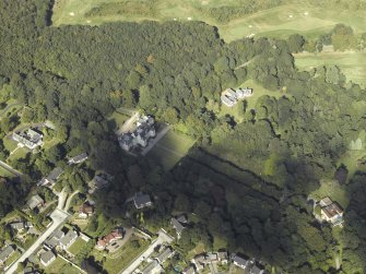 Oblique aerial view centred on the country house, gardens and dovecot with the cottages adjacent, taken from the S.