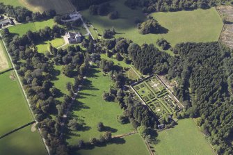 General oblique aerial view centred on the tower-house, walled garden and remains of the chapel, taken from the E.