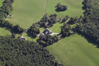 Oblique aerial view centred on the country house, hotel and hall-house with the cottage adjacent, taken from the NNW.