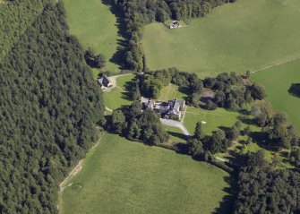 Oblique aerial view centred on the country house, hotel and hall-house with the cottage adjacent, taken from the WNW.