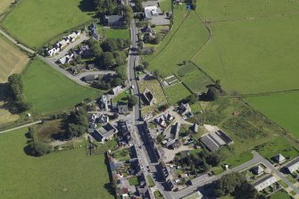 Oblique aerial view centred on the churches, burial-ground and schoolhouse and the ruins of the church, taken from the WNW.