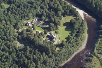Oblique aerial view centred on the country house, lodge and garden, taken from the NW.