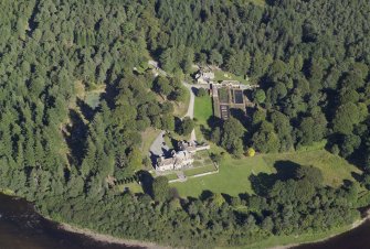 Oblique aerial view centred on the country house, lodge and garden, taken from the WSW.