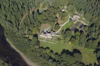 Oblique aerial view centred on the country house, lodge and garden, taken from the SW.
