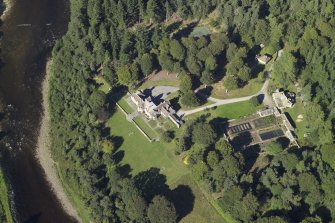 Oblique aerial view centred on the country house, lodge and garden, taken from the SSW.