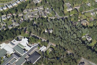 Oblique aerial view centred on the church and the school, taken from the S.