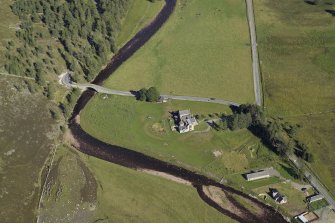 Oblique aerial view centred on the lodge with the road bridge adjacent, taken from the W.