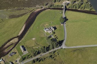 Oblique aerial view centred on the lodge with the road bridge adjacent, taken from the S.