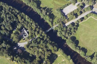 Oblique aerial view centred on the road bridge and lodge, taken from the S.