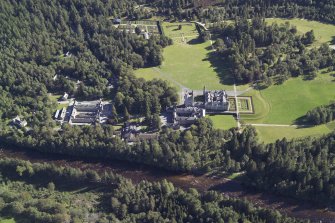 Oblique aerial view centred on the country house and garden with the cottages, kennels and walled garden adjacent, taken from the NNW.