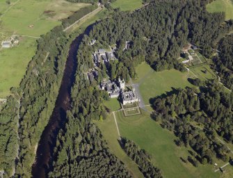 Oblique aerial view centred on the country house and garden with the cottages, kennels and walled garden adjacent, taken from the WSW.