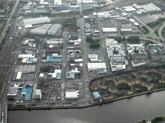 General oblique aerial view of Tradeston centred on the warehouses, works and housing, taken from the ENE.