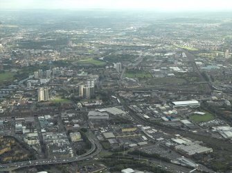 General oblique aerial view of the city with Tradeston in the foreground looking along the route of the proposed M74 extension, taken from the WNW.