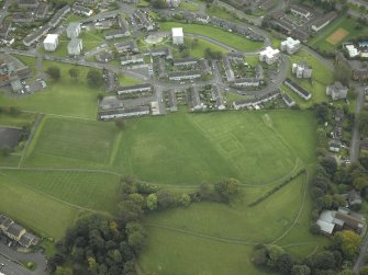 NNW oblique aerial view of Duntocher Roman Fort and Fortlet with  adjacent Trinity Parish Church.