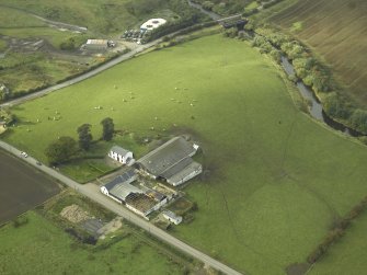 SE oblique aerial view of Balmuildy  Roman fort, the course of the Antonine Wall and adjacent Balmuildy road bridge.
