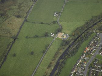 SW oblique aerial view of Auchendavy Roman fort and the course of the Antonine Wall and the military way.