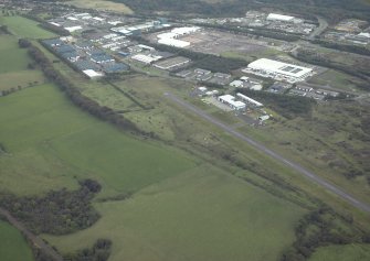 General oblique aerial view centred on the course of the Antonine Wall and the Military Way with the airfield and airport adjacent, taken from the NW.