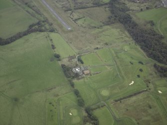 Oblique aerial view centred on the site of the Roman fort, possible Roman fortlet and the course of the Antonine Wall and the Military Way with the airfield adjacent, taken from the WNW.