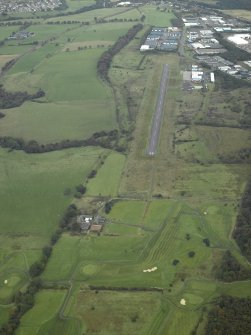 WSW oblique aerial view of Westerwood Roman Fort and possible fortlet, course of the Antonine Wall and Military Way and adjacent Cumbernauld airfield and airport.