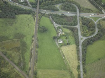 Oblique aerial view centred on the site of the Roman fort and Roman road, taken from the E.