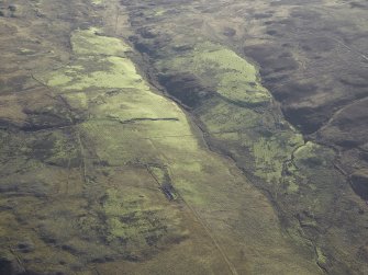 General oblique aerial view centred on the remains of the farmstead, chapel, enclosure, townships, rig and lazy beds, taken from the NNW.