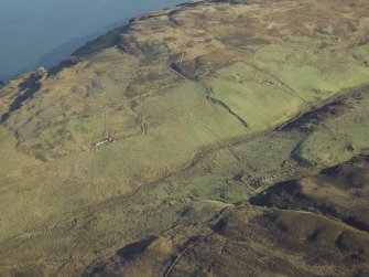 General oblique aerial view centred on the remains of the farmstead, chapel, enclosure, townships, rig and lazy beds, taken from the WSW.