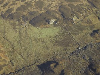 Oblique aerial view centred on the remains of the watermill, township, rig and field-system, taken from the SW.