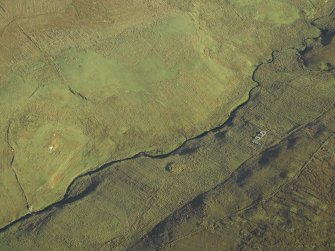 Oblique aerial view centred on the remains of the farmstead and chapel with the remains of the building and farmstead adjacent, taken from the WSW.