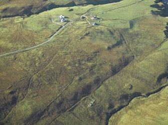 General oblique aerial view centred on the remains of the farmstead, building and chapel with the township adjacent, taken from the NE.